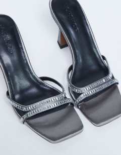 Model wearing Fifi embellished flare heel sandal in silver 