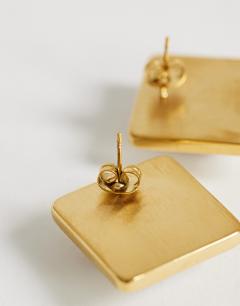 Model wearing Fifi waterproof stainless steel stud 2 tone earrings in silver and gold