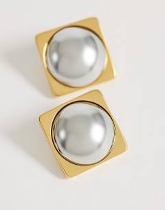 Model wearing Fifi waterproof stainless steel stud 2 tone earrings in silver and gold