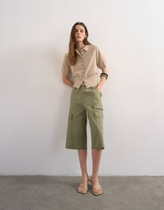 Model wearing Fine knitted cinch waist polo in oat