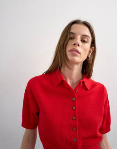 Model wearing Fine knitted short sleeve cinch waist polo in red