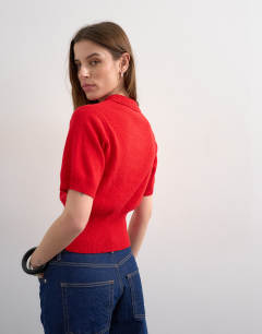 Model wearing Fine knitted short sleeve cinch waist polo in red