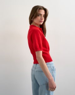 Model wearing Fine knitted towelling cinch waist polo in red