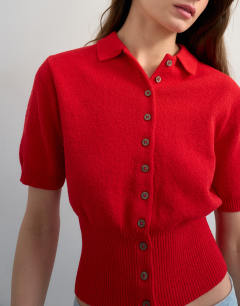Model wearing Fine knitted towelling cinch waist polo in red
