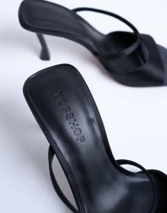 Model wearing Fiona high heel mule with strap in black