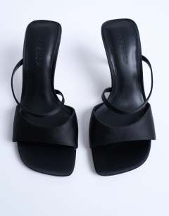 Model wearing Fiona high heel mule with strap in black