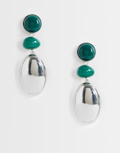 Model wearing Fiona triple drop earrings in green and silver