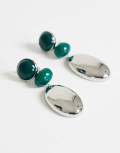 Model wearing Fiona triple drop earrings in green and silver