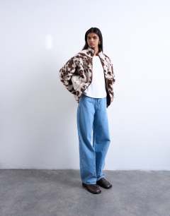 Model wearing Fleece borg jacket in cow print