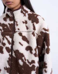 Model wearing Fleece borg jacket in cow print