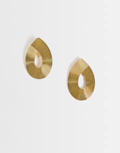 Model wearing Flick stud earring in gold