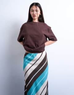Model wearing Flood length cupro maxi bias skirt in brown and blue stripe