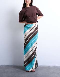 Model wearing Flood length cupro maxi bias skirt in brown and blue stripe