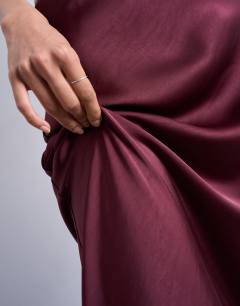 Model wearing Flood length maxi bias skirt in burgundy