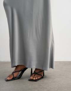 Model wearing Flood length satin bias maxi skirt in grey