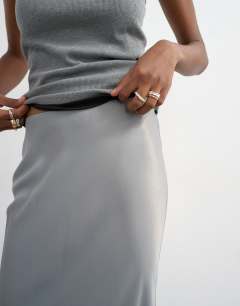 Model wearing Flood length satin bias maxi skirt in grey