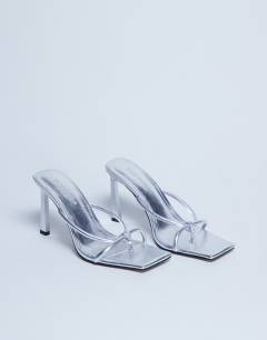 Model wearing Flora strappy toe loop high heel in silver