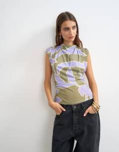Model wearing Floral printed drape back top in purple
