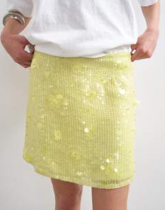 Model wearing Floral sequin mini skirt with tie sides in yellow