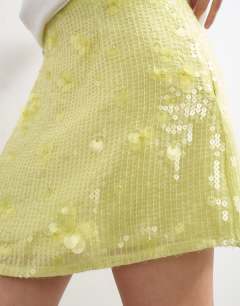Model wearing Floral sequin mini skirt with tie sides in yellow