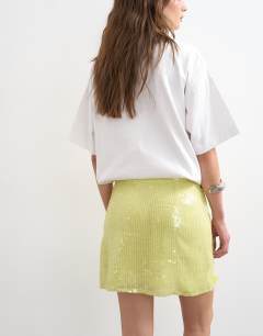 Model wearing Floral sequin mini skirt with tie sides in yellow