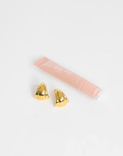 Model wearing Flossie stainless steel earring in gold