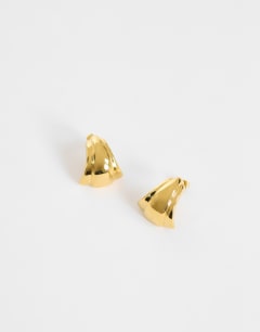 Model wearing Flossie stainless steel earring in gold