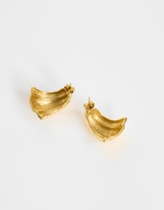Model wearing Flossie stainless steel earring in gold