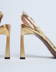 Model wearing Floyd strappy buckle detail square toe high heel in gold