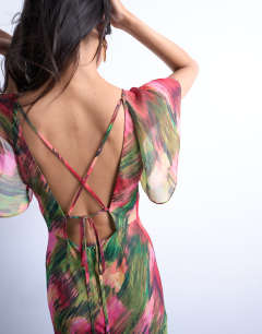 Model wearing Flutter sleeve godet hem midi dress in blurred floral