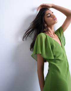 Model wearing Flutter sleeve godet hem midi dress in green