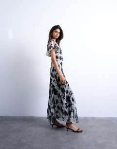 Model wearing Flutter sleeve godet hem midi dress in mono print