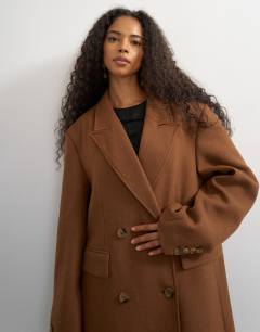 Model wearing Formal double breasted longline coat in toffee