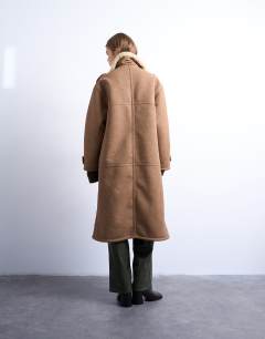 Model wearing Formal longline shearling coat in brown and cream