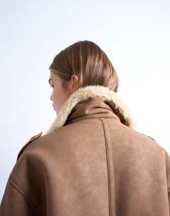 Model wearing Formal longline shearling coat in brown and cream