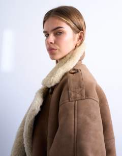 Model wearing Formal longline shearling coat in brown and cream
