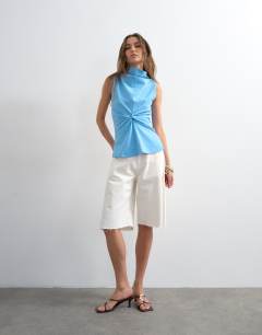 Model wearing Formal twist front funnel cowl top in blue