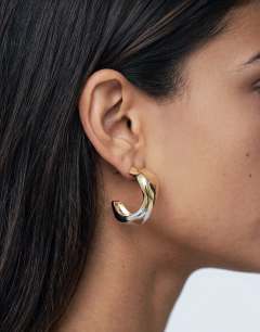 Model wearing Foster two tone hoop earring in gold and silver