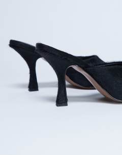 Model wearing Fox heeled mule in black hair on real leather