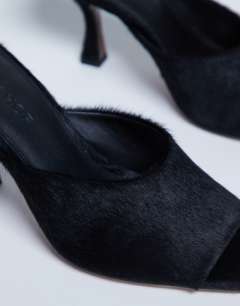 Model wearing Fox heeled mule in black hair on real leather