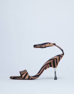 Model wearing Fran high heel sandal with metal in tiger print hair on real leather