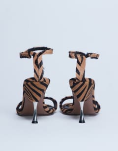 Model wearing Fran high heel sandal with metal in tiger print hair on real leather