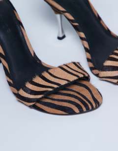 Model wearing Fran high heel sandal with metal in tiger print hair on real leather