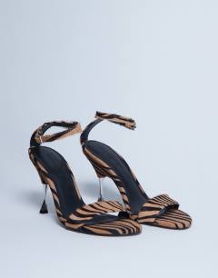Model wearing Fran real leather pony with metal high heel in tiger pony