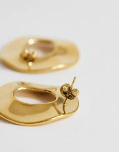 Model wearing Francis waterproof stainless steel round earrings in gold brushed