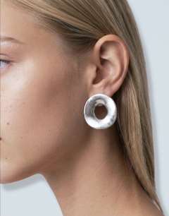 Model wearing Francis waterproof stainless steel round earrings in silver brushed