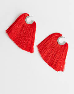 Model wearing Franklin hoop tassel earrings in red