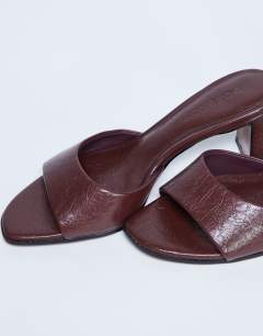 Model wearing Freya heeled mule in burgundy