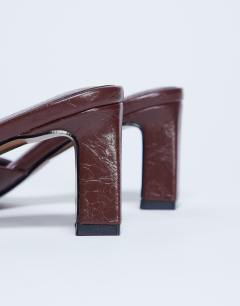 Model wearing Freya heeled mule in burgundy