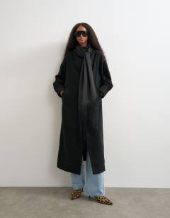 Model wearing Fringe detail belted longline coat with wool in black